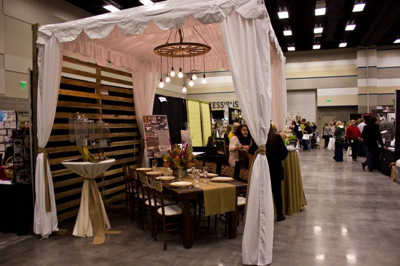 Elegant wedding expo booth with draped fabrics
