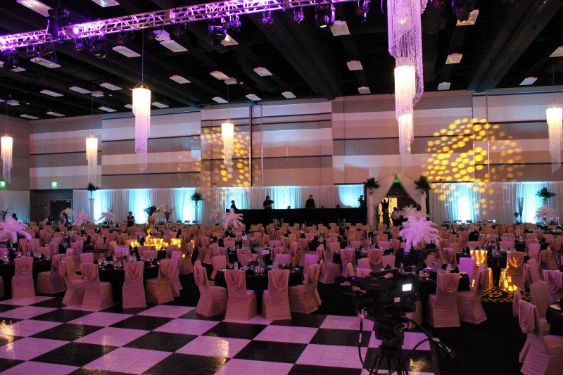Elegant banquet hall with pink lit decor