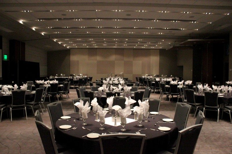 white tablecloths, and folded napkins under dim lighting