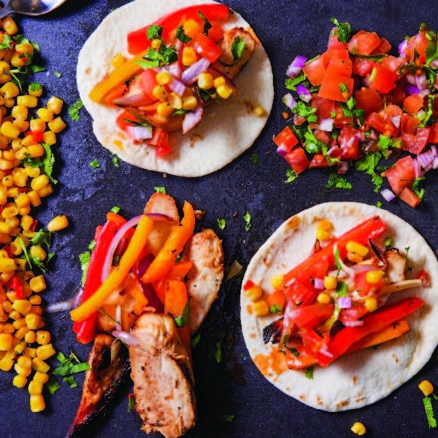 fajita plate with tortillas, pico de gallo, rice, and corn