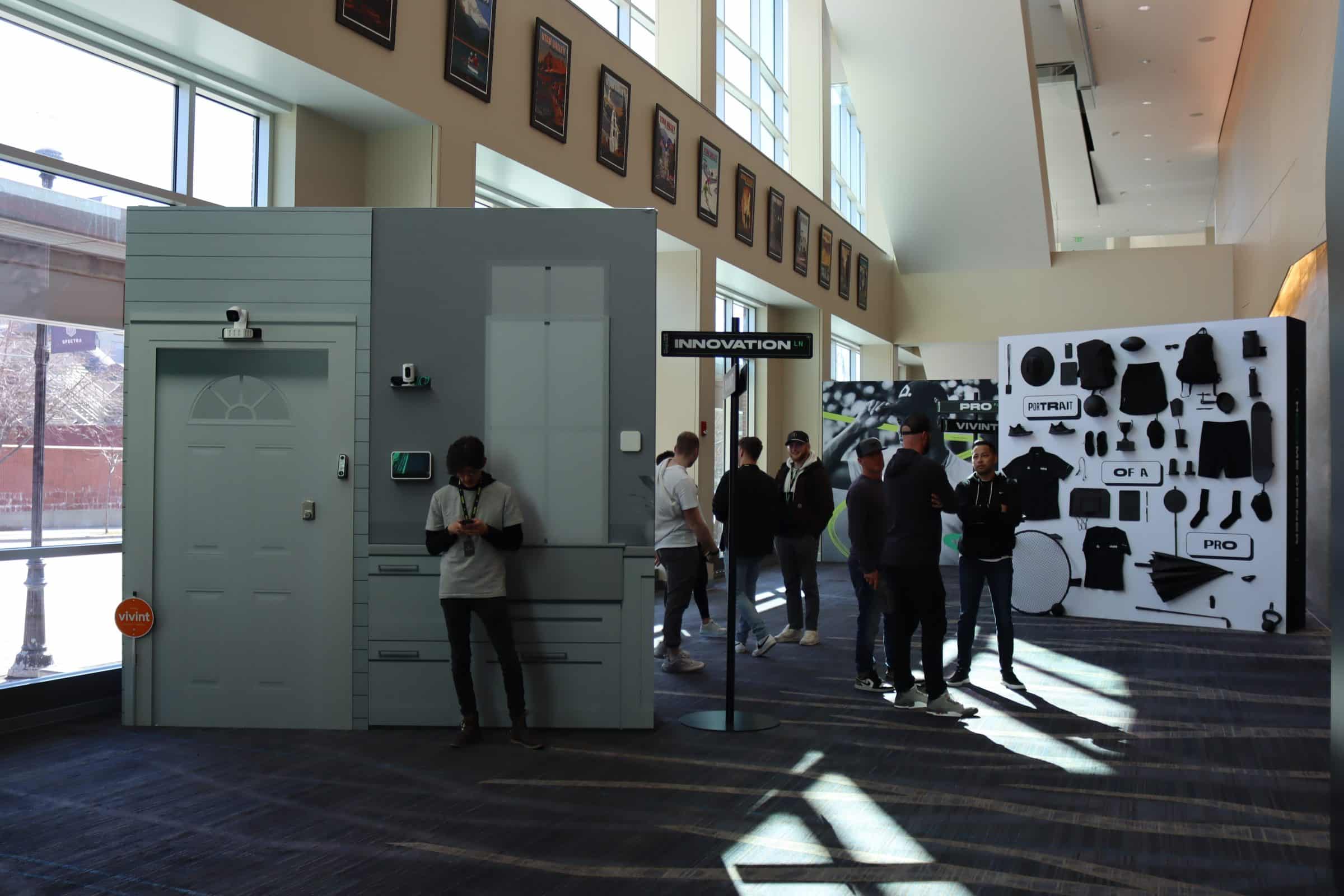 Display items in hallway with people looking at them.