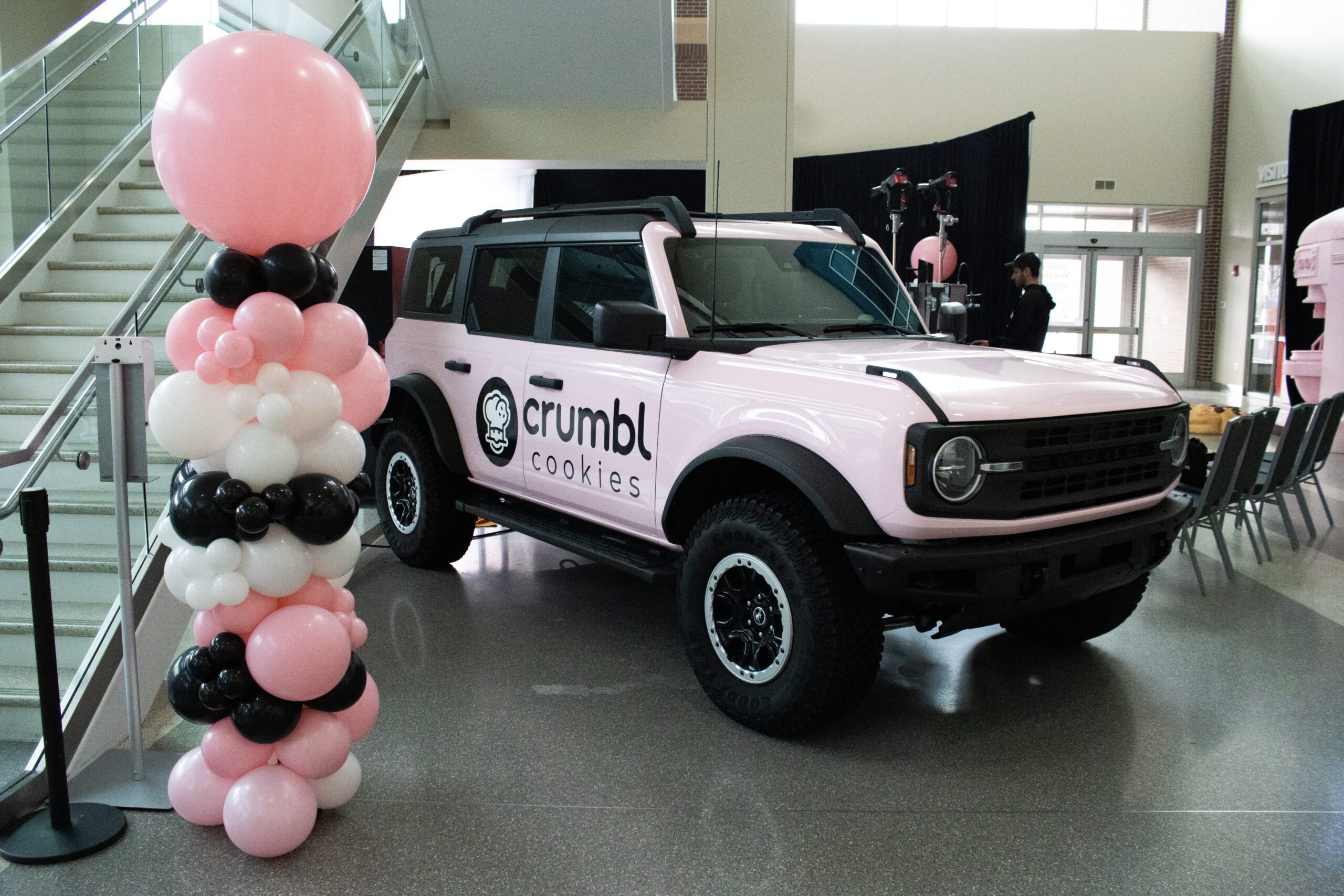pink ford bronco and balloons parked in the lobby