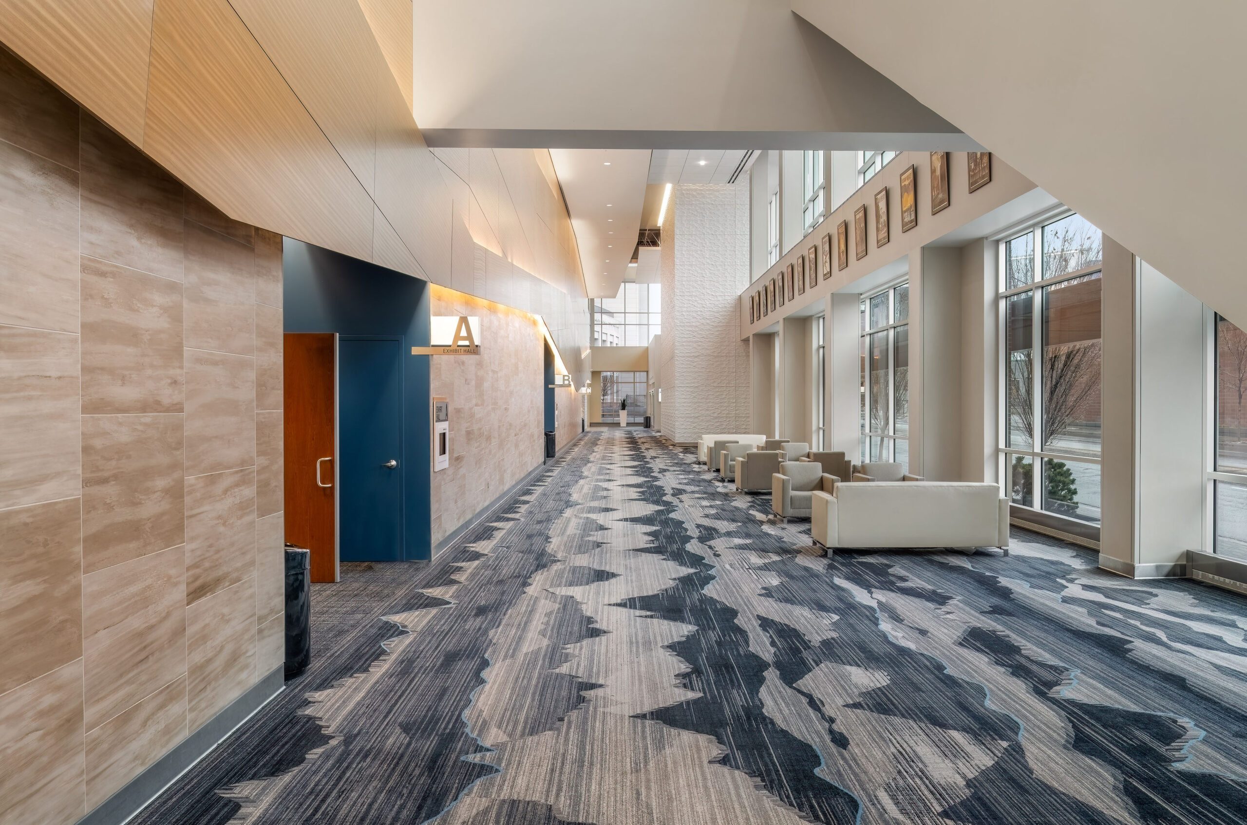Modern lobby with geometric carpet, beige seating