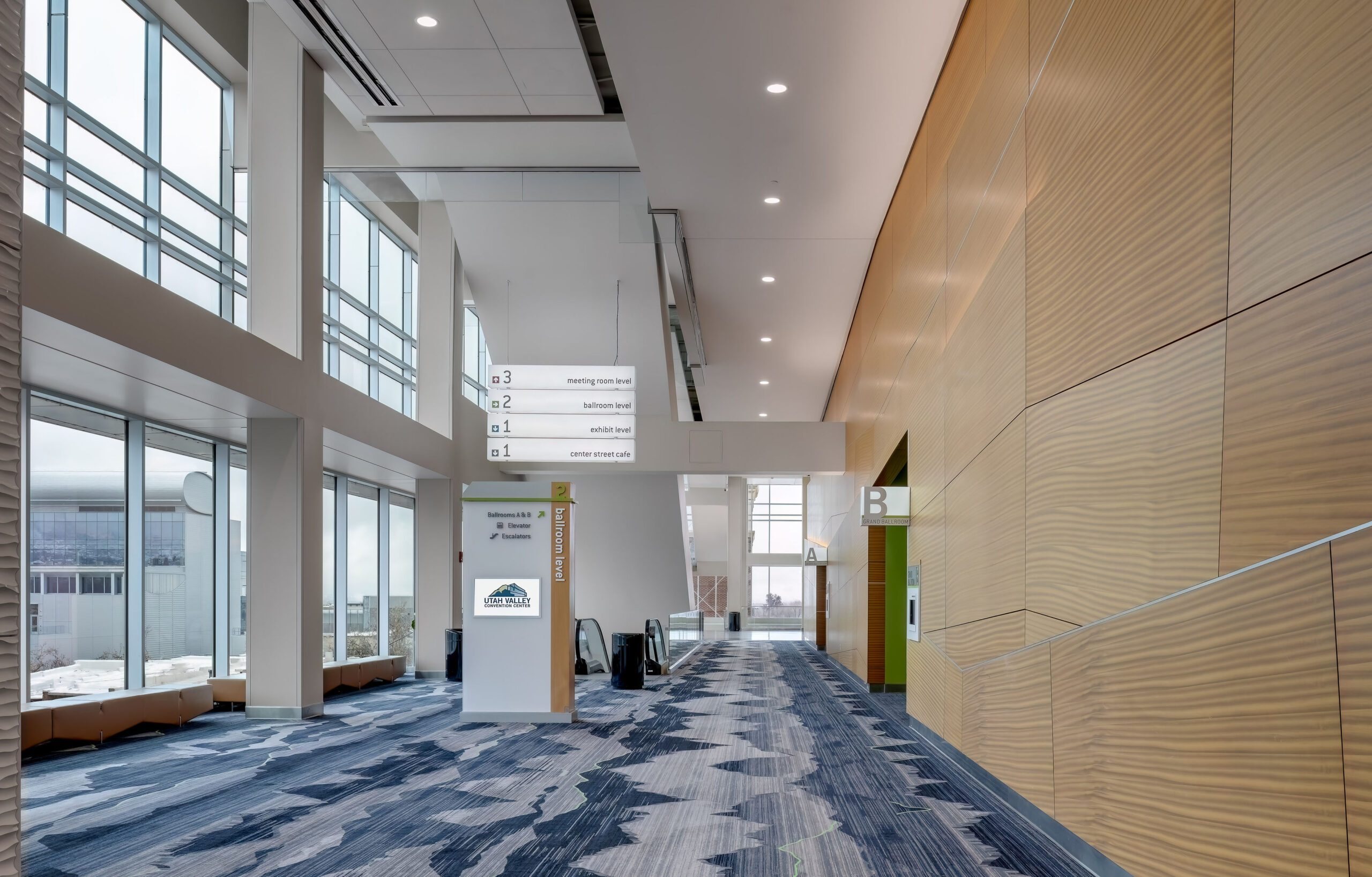 Modern convention center interior with directional signs