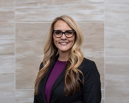 woman in purple shirt with black blazer