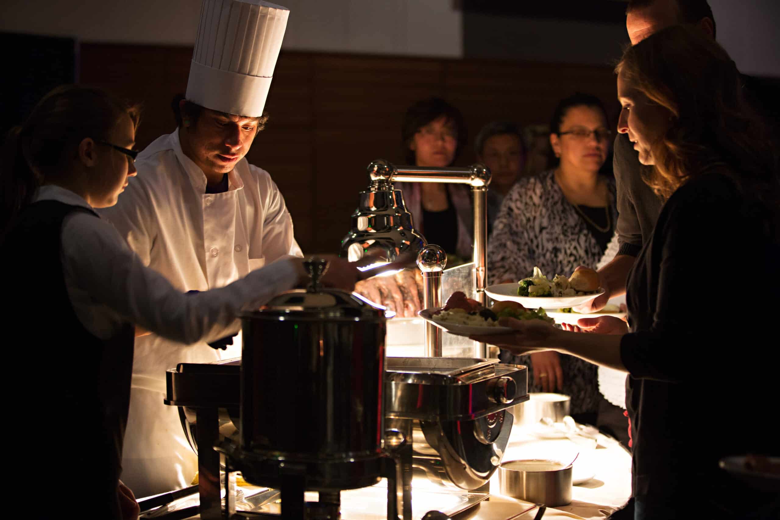 chef serving food during holiday party