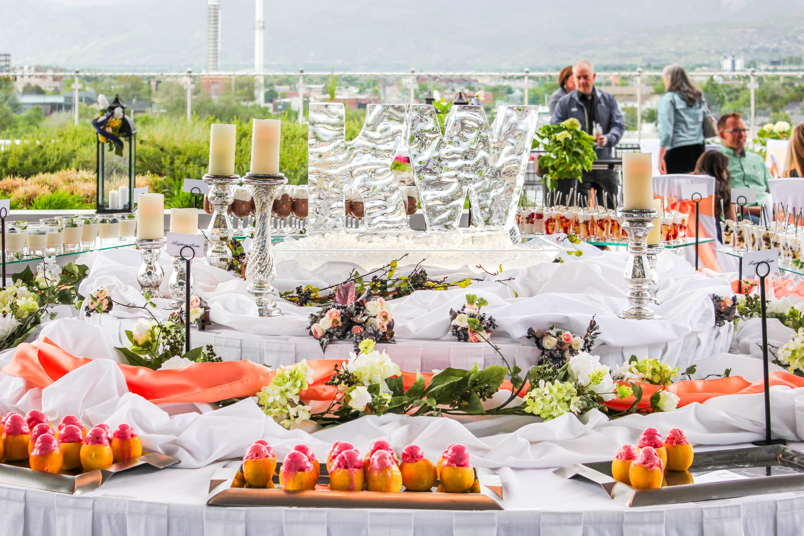 ice sculpture, lit candles, and fruit arrangements