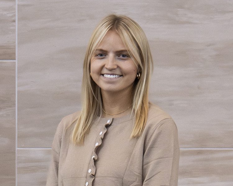 smiling blonde woman with button up sweater